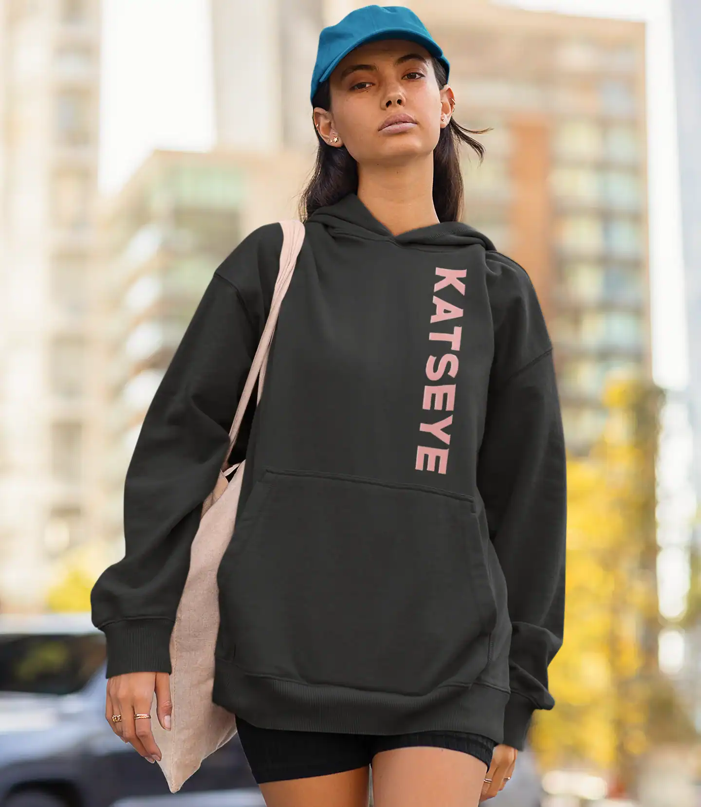 model wearing black katseye unisex hoodie